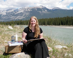 Kendra painting in Jasper beside the Athabasca River during her week as Artist in Residence with Mountain Galleries