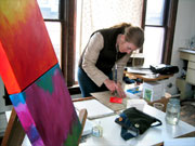 Kendra painting in her studio